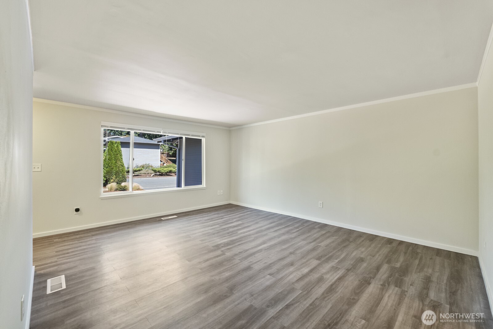 210 219th Place Southwest Bothell, WA 98021 - Photo 7 of 31 a view of an empty room with wooden floor and a window