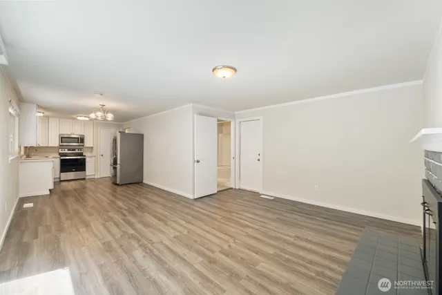 a view of empty room with wooden floor