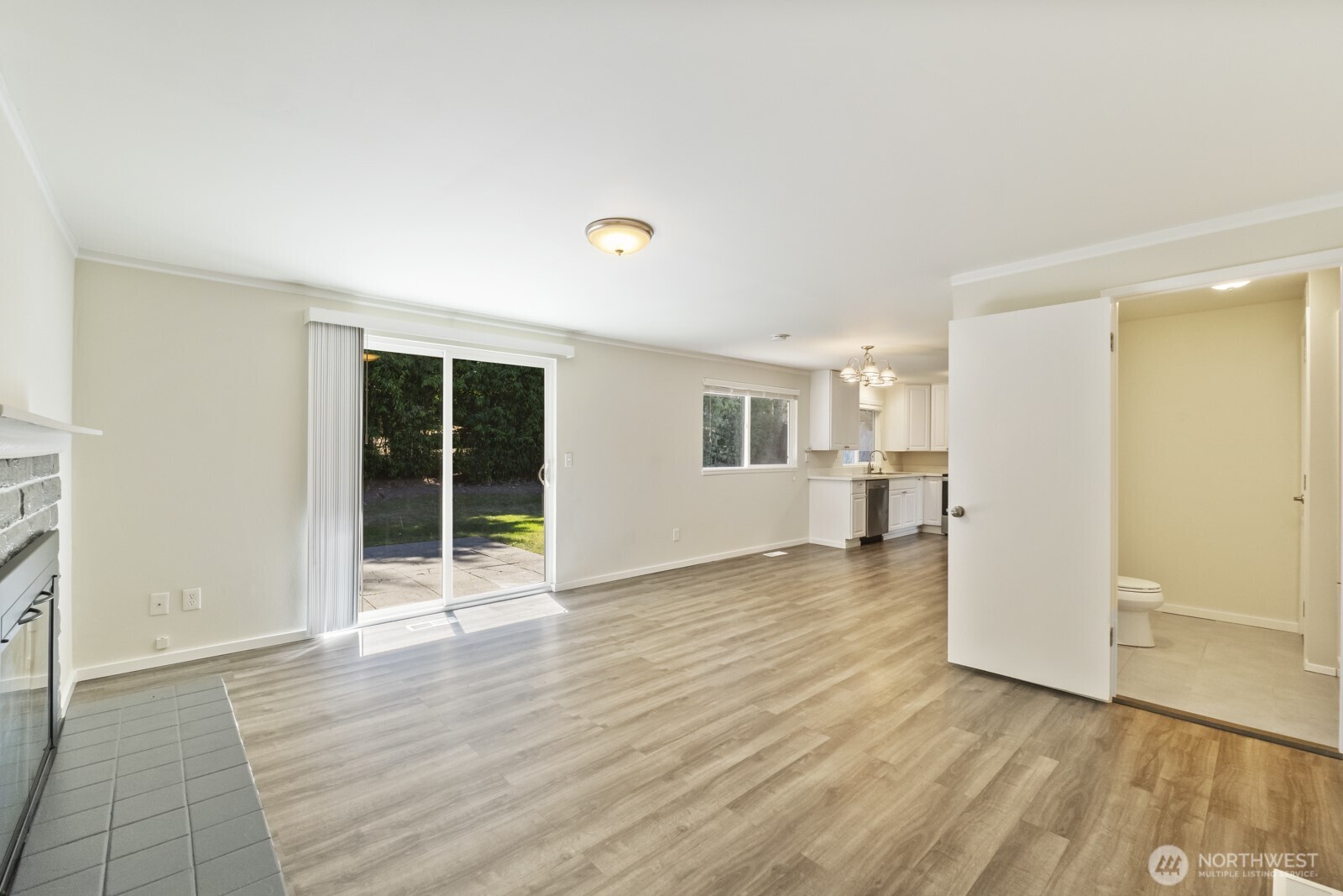 210 219th Place Southwest Bothell, WA 98021 - Photo 9 of 31 an empty room with wooden floor and windows