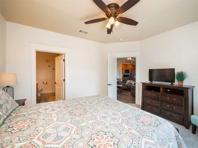 a bedroom with a bed and a television