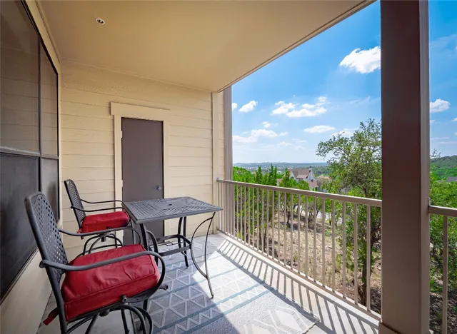 a view of a balcony with furniture