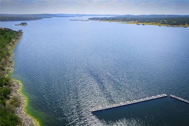 an aerial view of residential houses with outdoor space and street view