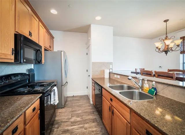 a kitchen that has a sink a stove and a oven