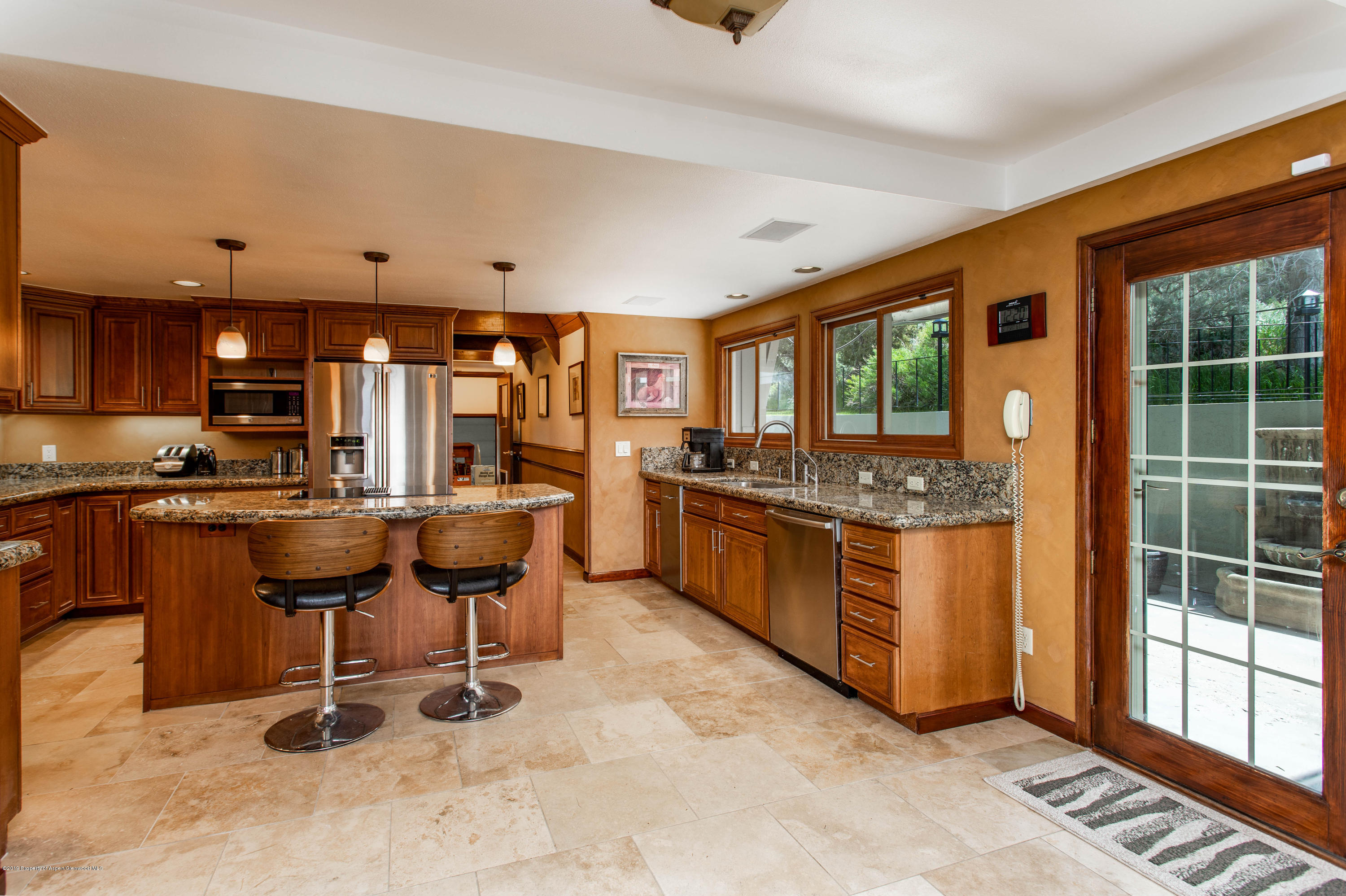 362 Panoramic Drive Silt, CO 81652 - Photo 10 of 43 a kitchen with stainless steel appliances kitchen island granite countertop a stove a sink and a refrigerator