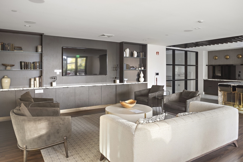 99 Sumner Street, Unit 413 Boston, MA 02128 - Photo 16 of 21 a living room with furniture and a flat screen tv