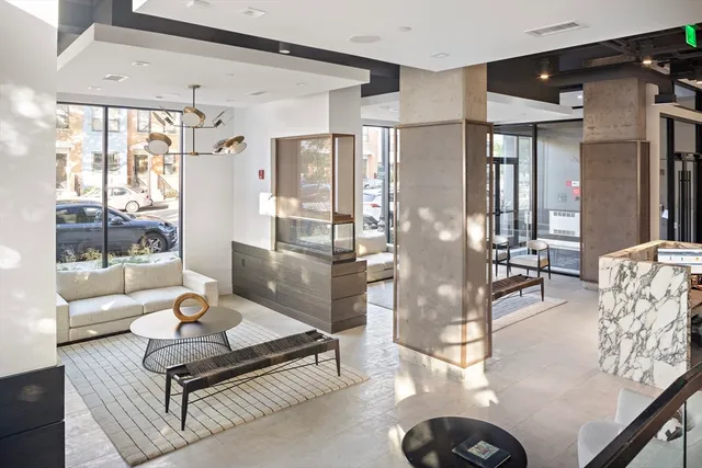 a living room with furniture and a floor to ceiling window