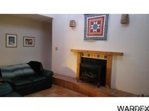 16955 South Lone Ranger Road Yucca, AZ 86438 - Photo 15 of 16 a living room with furniture and a fireplace
