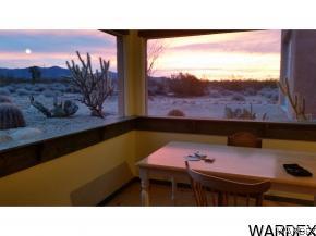 16955 South Lone Ranger Road Yucca, AZ 86438 - Photo 9 of 16 a balcony with furniture and a floor to ceiling window