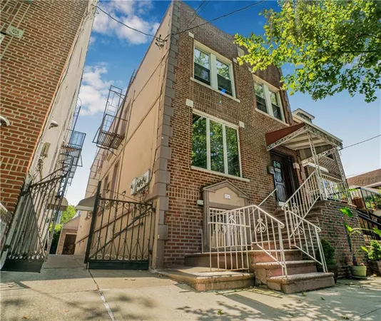 a view of a brick house with many windows