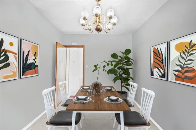 a view of a dining room with furniture a chandelier and wooden floor