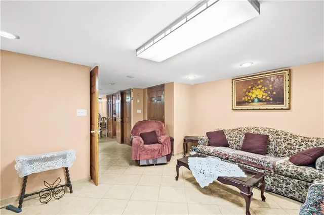 a living room with furniture and a painting on the wall