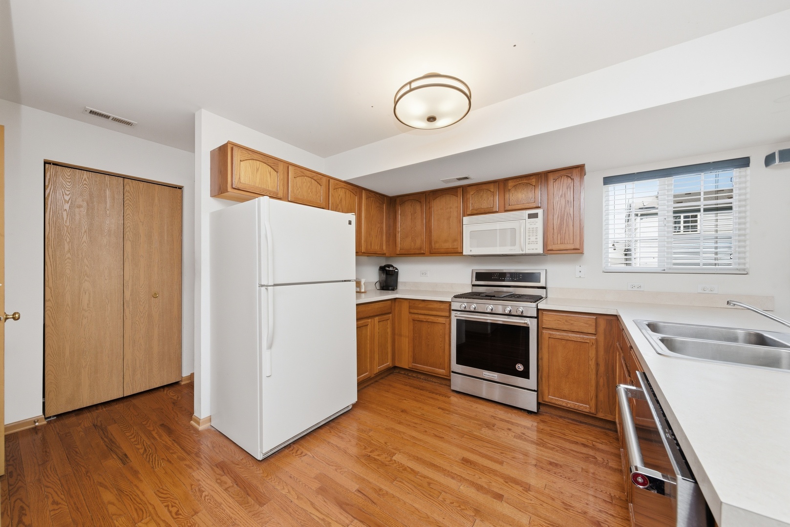 1758 Edith Lane Aurora, IL 60504 - Photo 3 of 23 a kitchen with a refrigerator stove and wooden cabinets