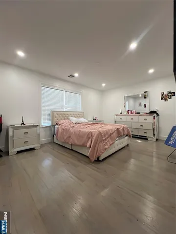 a spacious bedroom with a bed and a cabinets