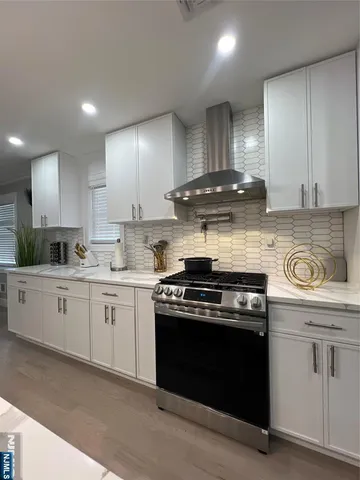 a kitchen with a stove top oven cabinets and stainless steel appliances