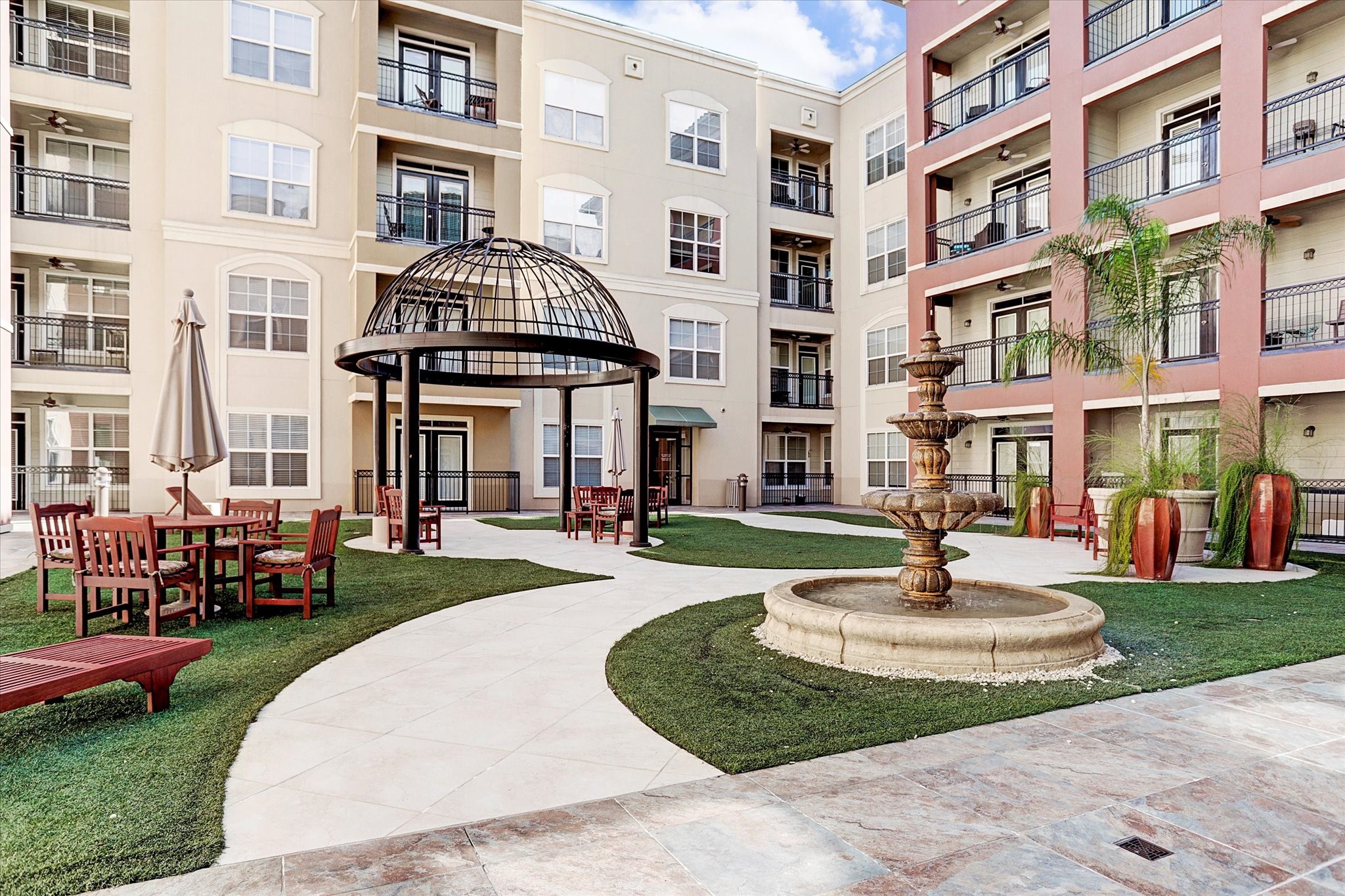 1711 Old Spanish Trail, Unit 448 Houston, TX 77054 - Photo 16 of 29 a front view of a building with a garden and plants