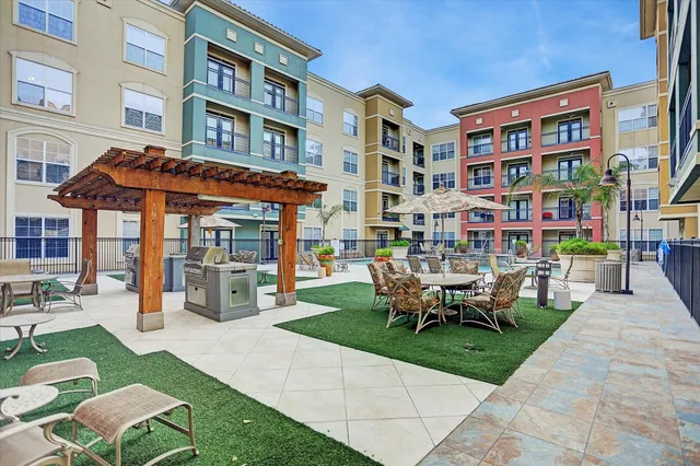 a view of a building with a garden and sitting area
