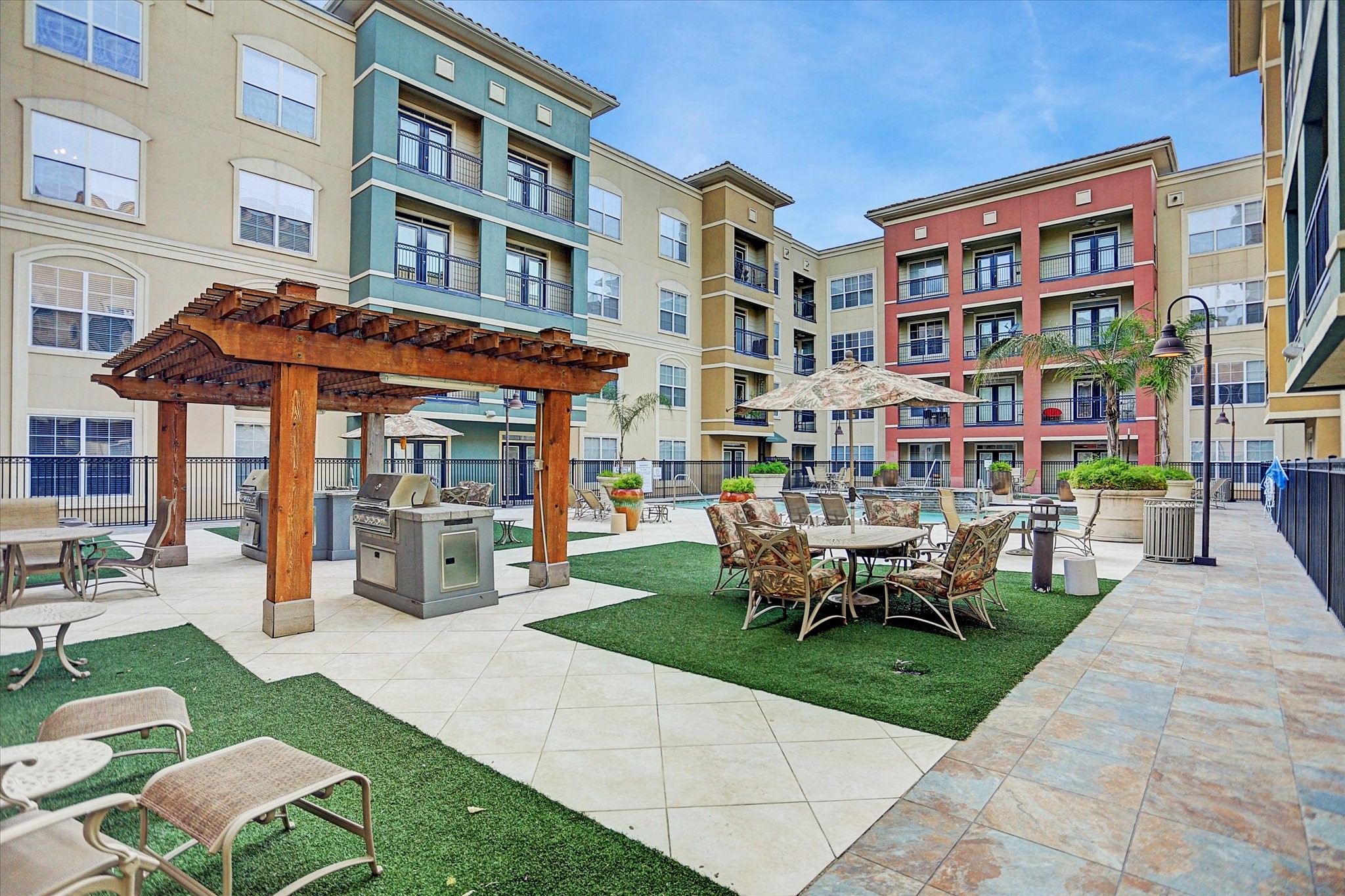 1711 Old Spanish Trail, Unit 448 Houston, TX 77054 - Photo 17 of 29 a view of a building with a garden and sitting area