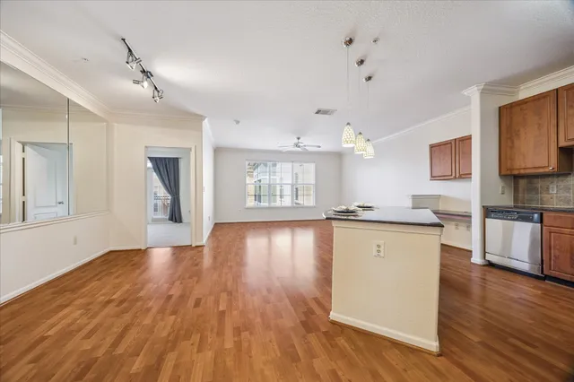 a view of a kitchen with wooden floor and a window