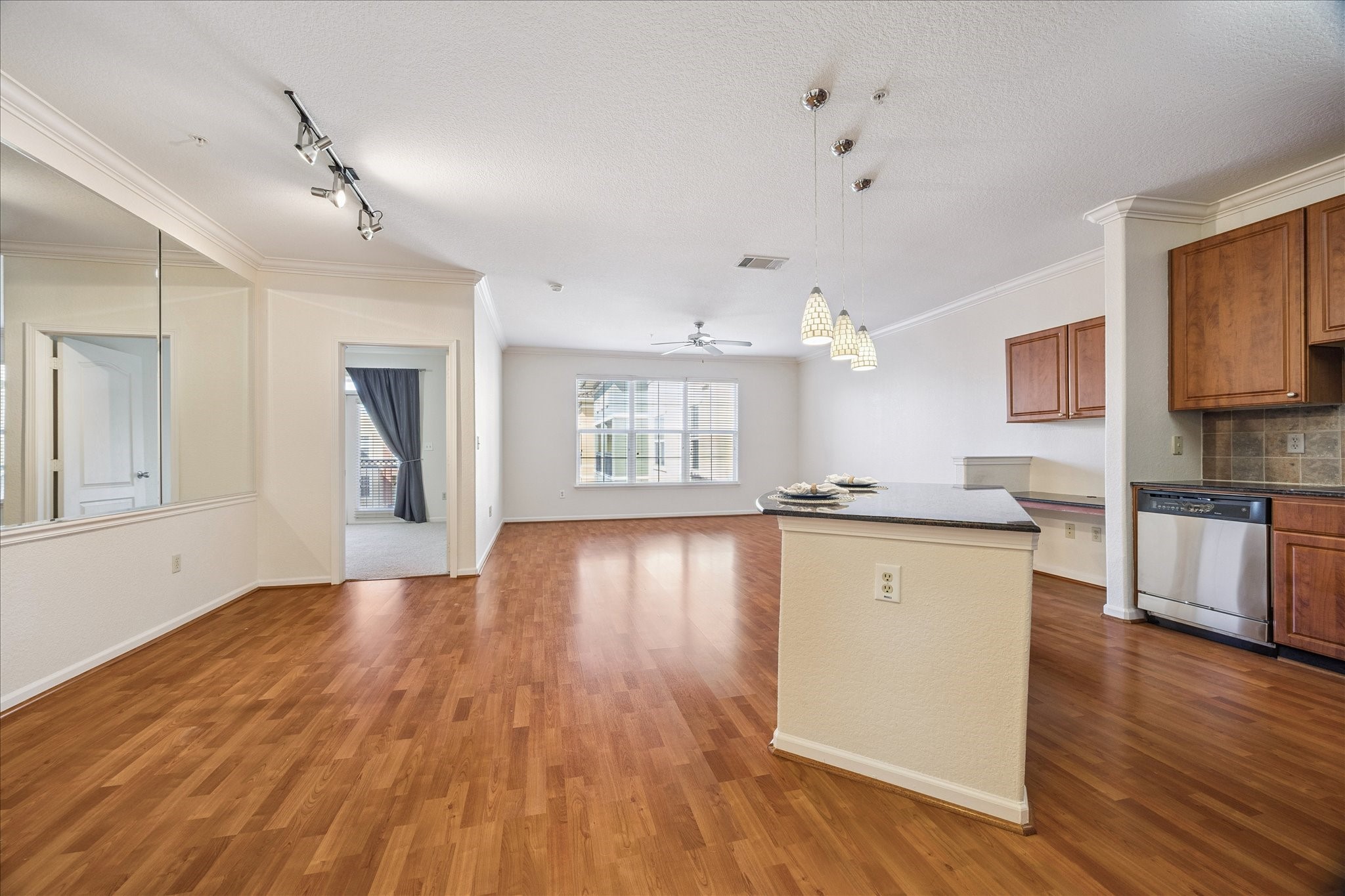 1711 Old Spanish Trail, Unit 448 Houston, TX 77054 - Photo 5 of 29 a view of a kitchen with wooden floor and a window