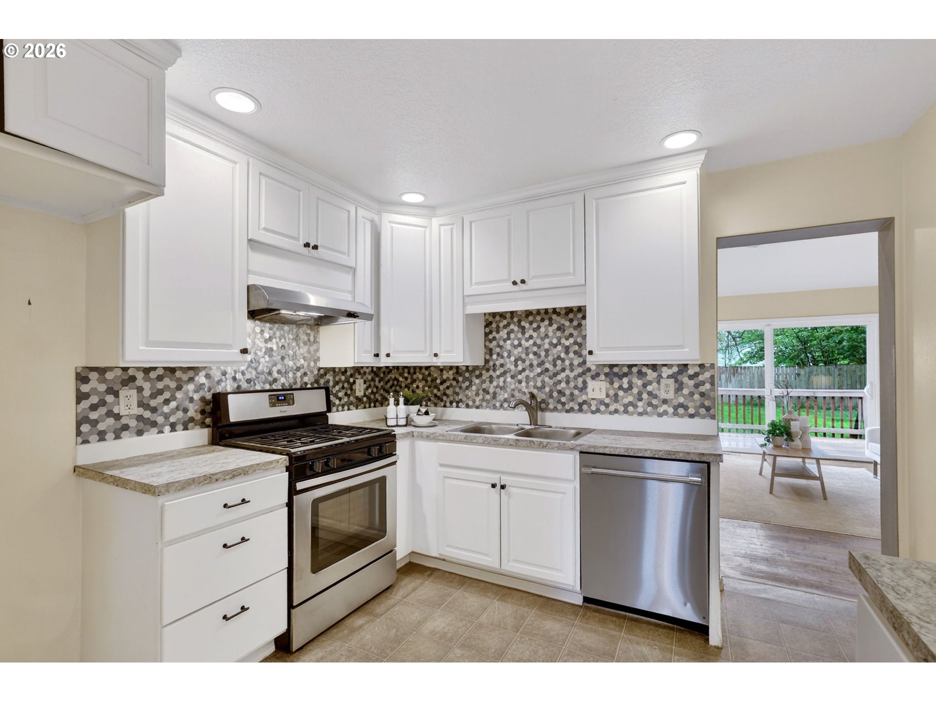 11824 Southeast Liebe Street Portland, OR 97266 - Photo 13 of 48 a kitchen with a stove a sink and a refrigerator