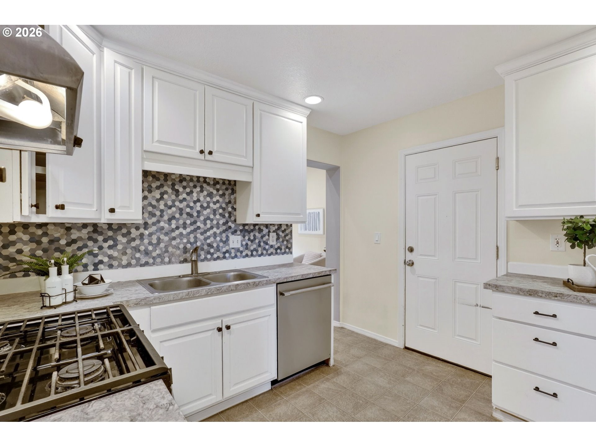 11824 Southeast Liebe Street Portland, OR 97266 - Photo 14 of 48 a kitchen with a sink stove and cabinets