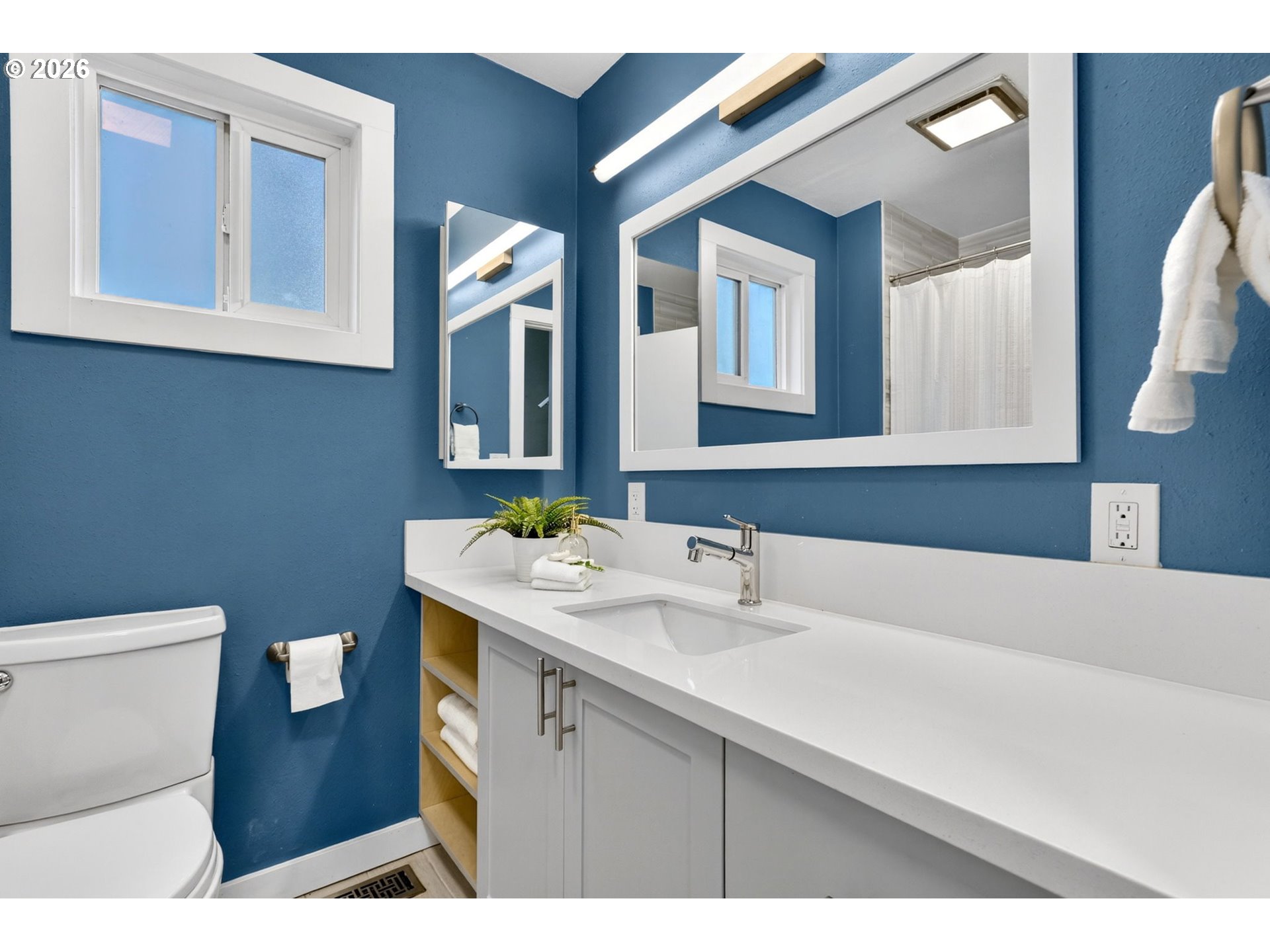 11824 Southeast Liebe Street Portland, OR 97266 - Photo 20 of 48 a bathroom with a sink a toilet and mirror