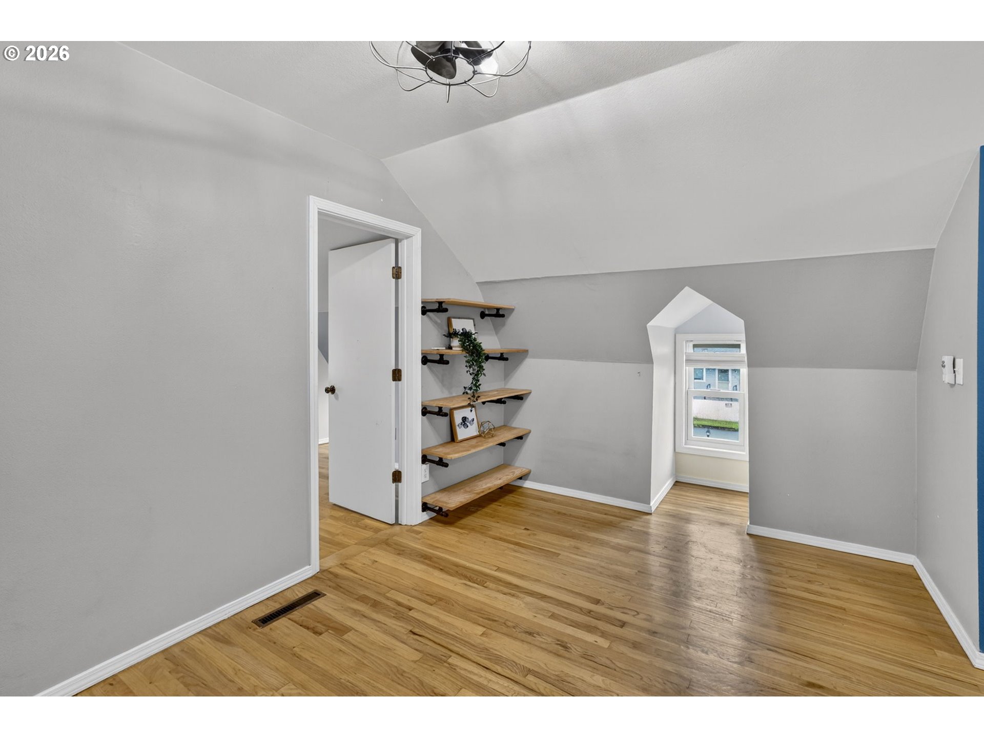 11824 Southeast Liebe Street Portland, OR 97266 - Photo 32 of 48 a view of empty room with wooden floor