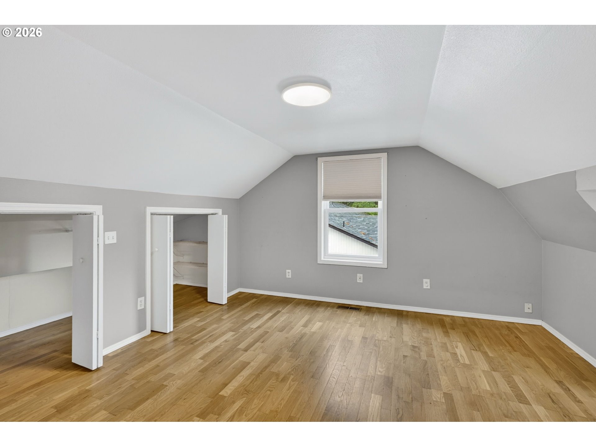11824 Southeast Liebe Street Portland, OR 97266 - Photo 36 of 48 an empty room with wooden floor and windows