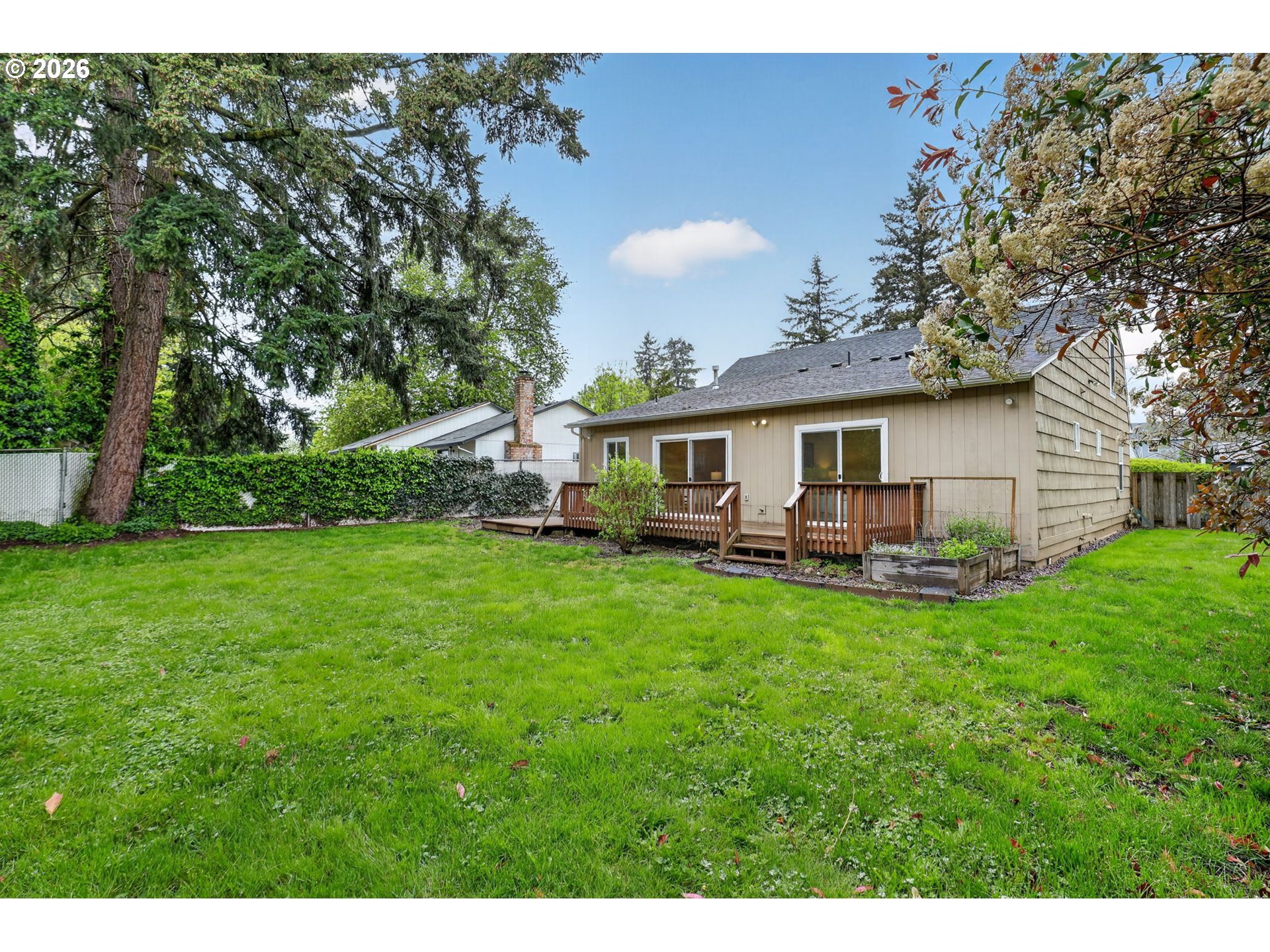 11824 Southeast Liebe Street Portland, OR 97266 - Photo 41 of 48 a view of a house with a backyard and a patio