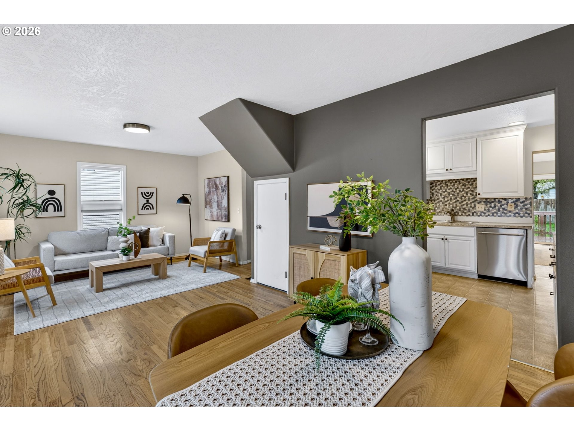 11824 Southeast Liebe Street Portland, OR 97266 - Photo 5 of 48 a living room with furniture potted plant and kitchen view