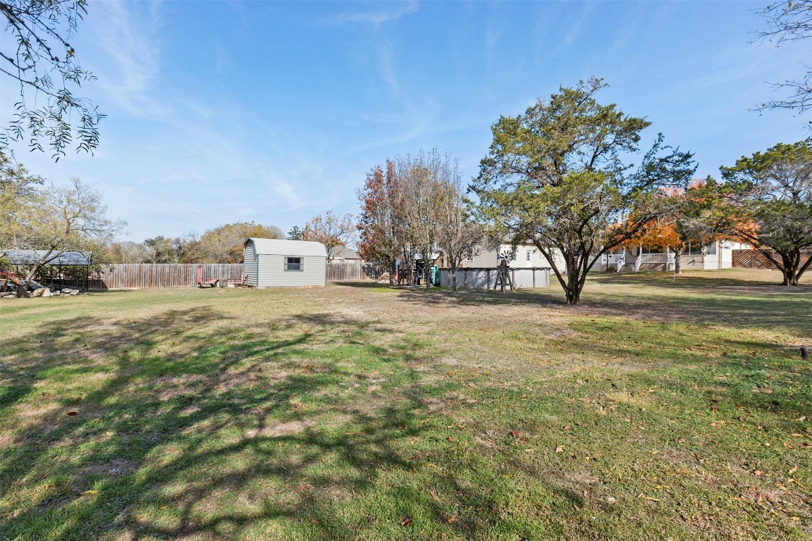 201 Millington Lane Buda, TX 78610 - Photo 24 of 28 Fenced backyard with a storage unit