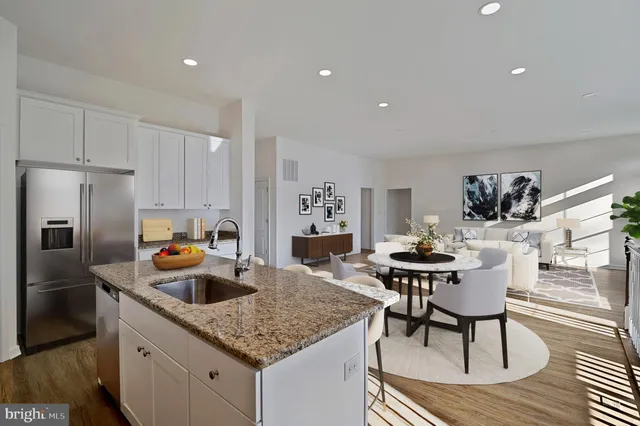 a kitchen with a table chairs and refrigerator