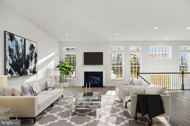 a living room with furniture fireplace and window