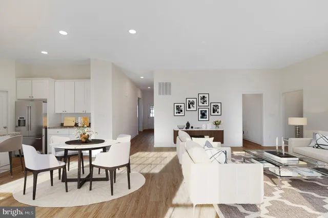 a living room with furniture a table and chairs