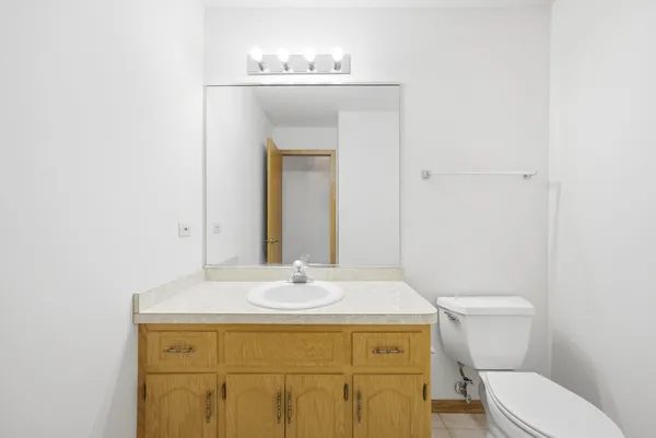 a bathroom with a sink and mirror with toilet