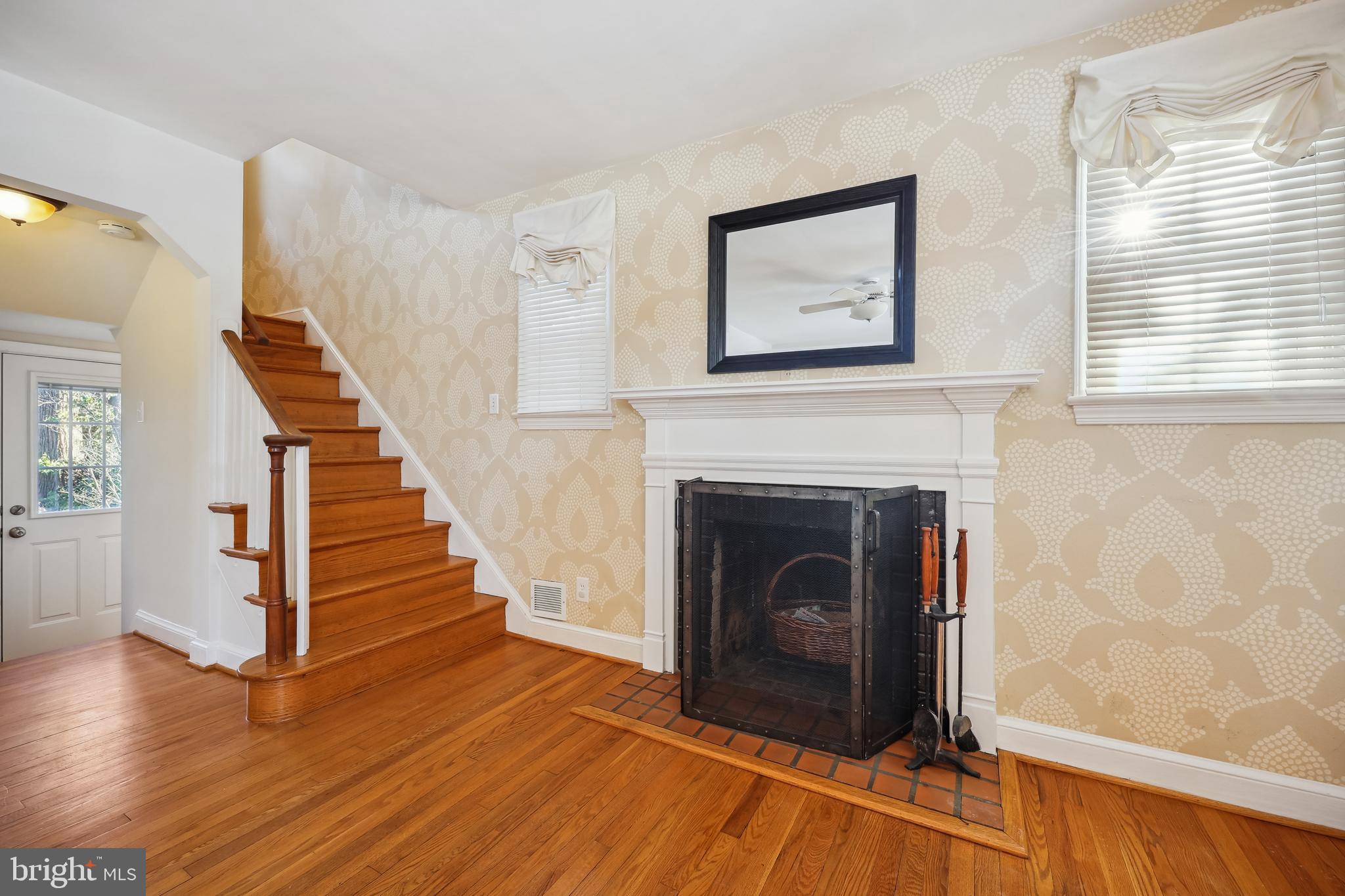 10121 Markham Street Silver Spring, MD 20901 - Photo 24 of 80 a view of a livingroom with wooden floor and a fireplace