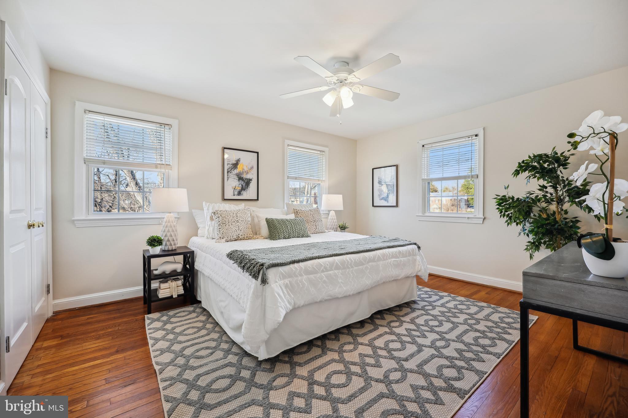 10121 Markham Street Silver Spring, MD 20901 - Photo 27 of 80 a spacious bedroom with a bed and a chandelier