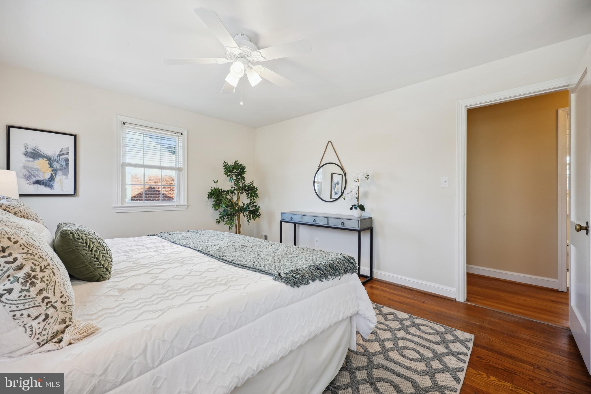 10121 Markham Street Silver Spring, MD 20901 - Photo 30 of 80 a bedroom with a bed and wooden floor