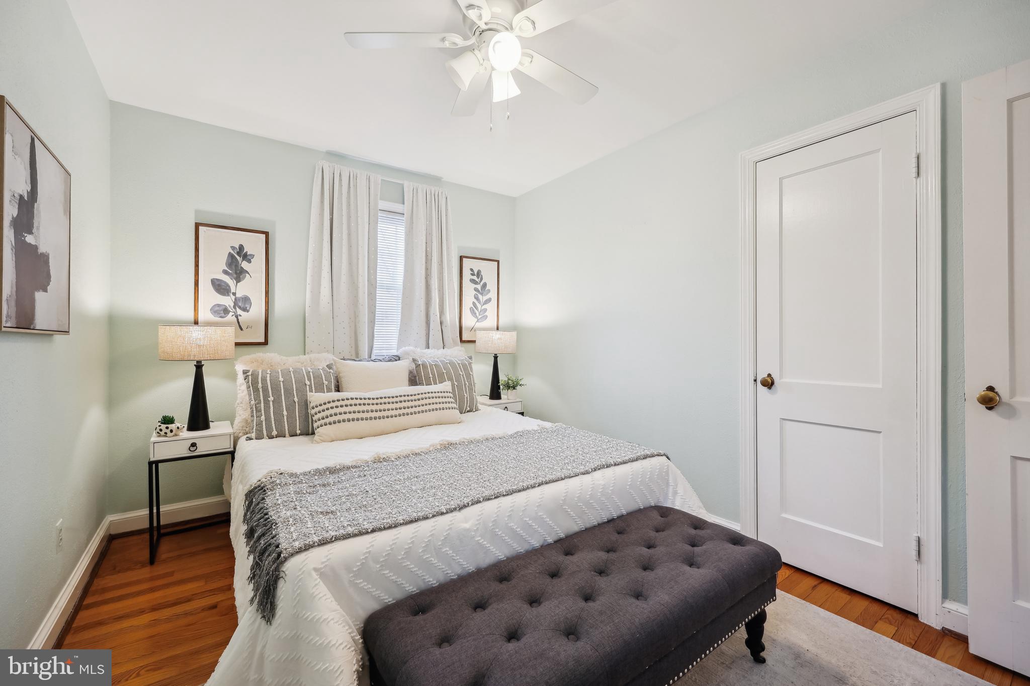10121 Markham Street Silver Spring, MD 20901 - Photo 32 of 80 a bedroom with a bed and a chandelier