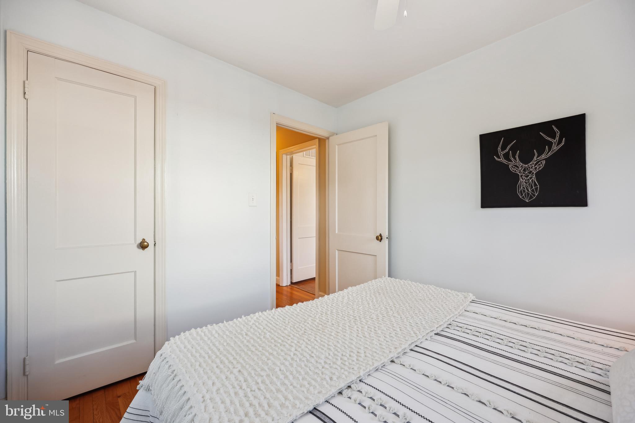 10121 Markham Street Silver Spring, MD 20901 - Photo 39 of 80 a bedroom with a bed and a wall painting
