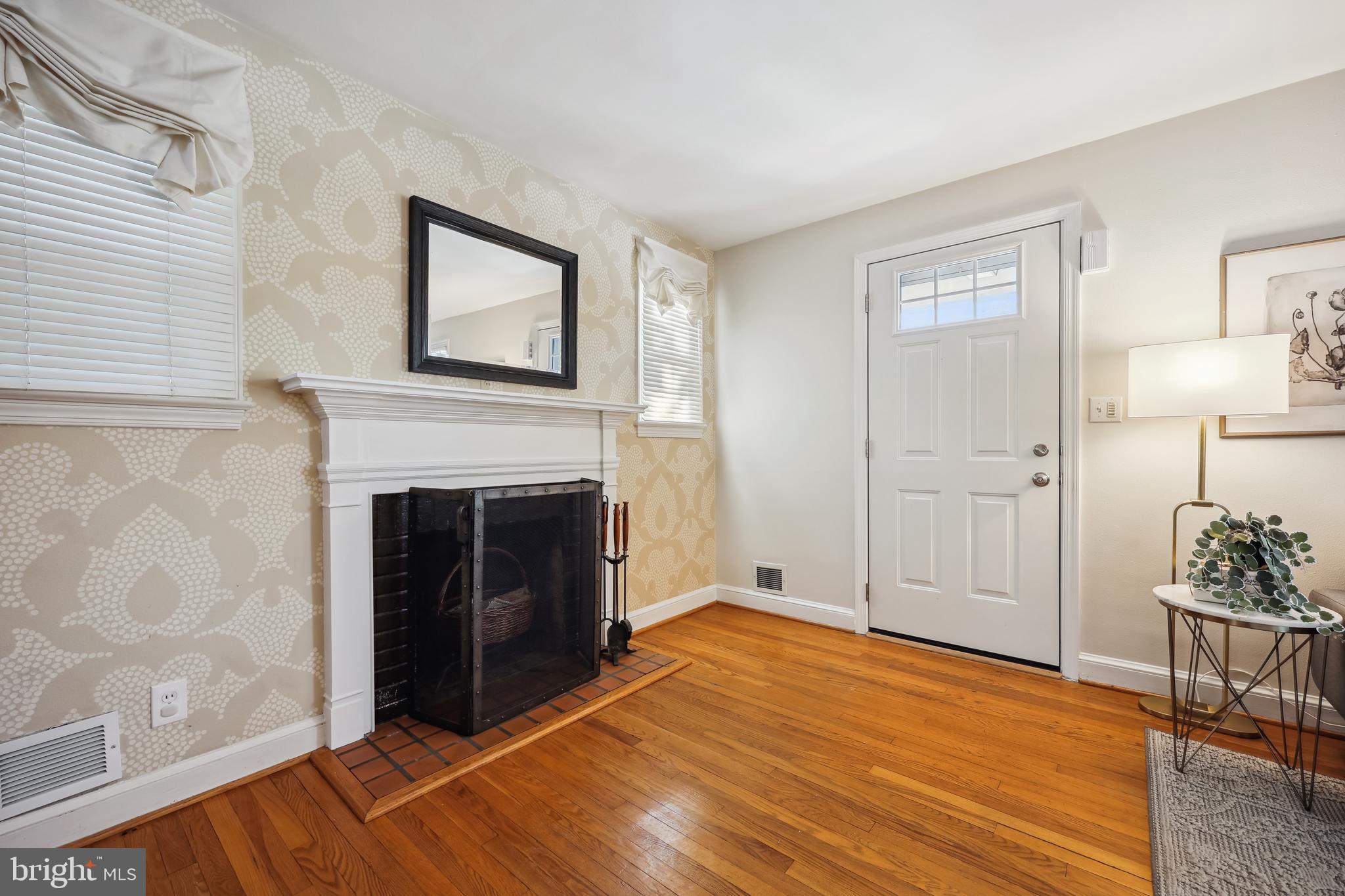 10121 Markham Street Silver Spring, MD 20901 - Photo 4 of 80 a view of a livingroom with an empty space and a fireplace
