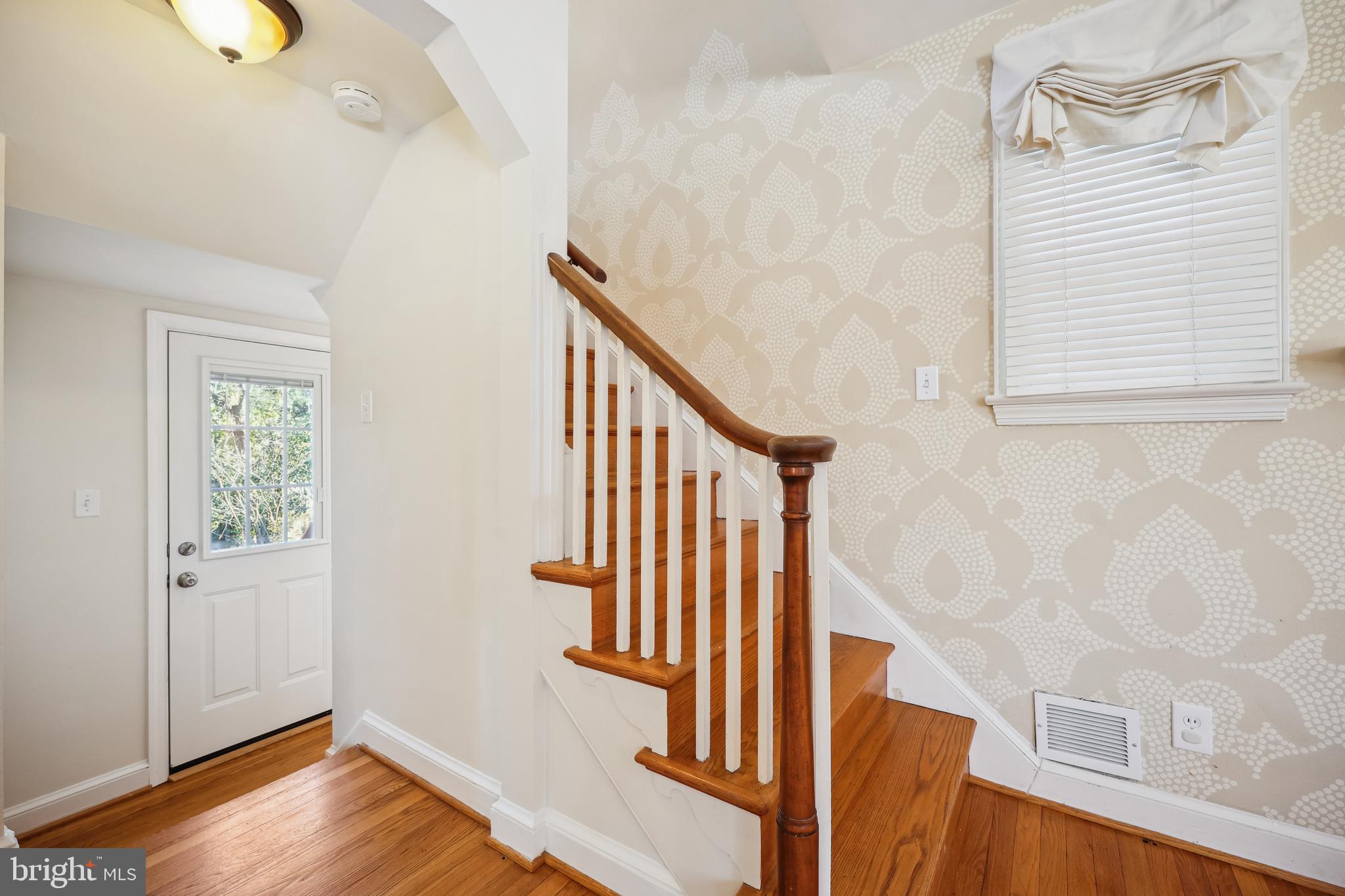 10121 Markham Street Silver Spring, MD 20901 - Photo 41 of 80 a view of an entryway with wooden floor and stairs