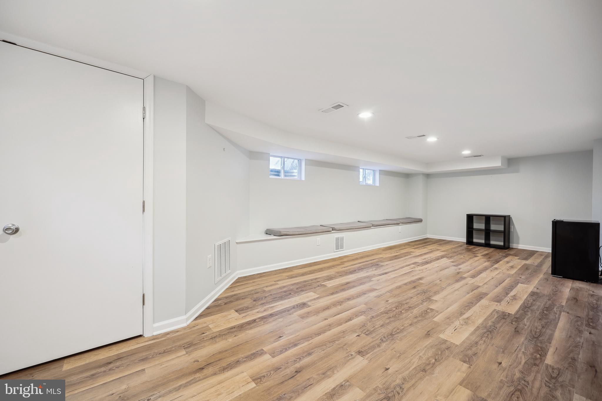 10121 Markham Street Silver Spring, MD 20901 - Photo 43 of 80 a view of an empty room with wooden floor