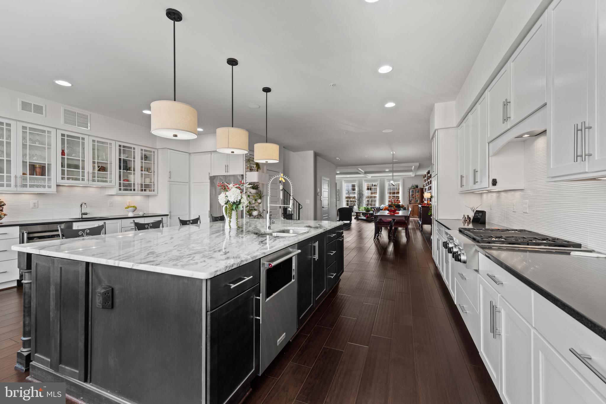 922 South Streeper Street Baltimore, MD 21224 - Photo 2 of 33 a large kitchen with stainless steel appliances granite countertop lots of counter space a sink and a wooden floors