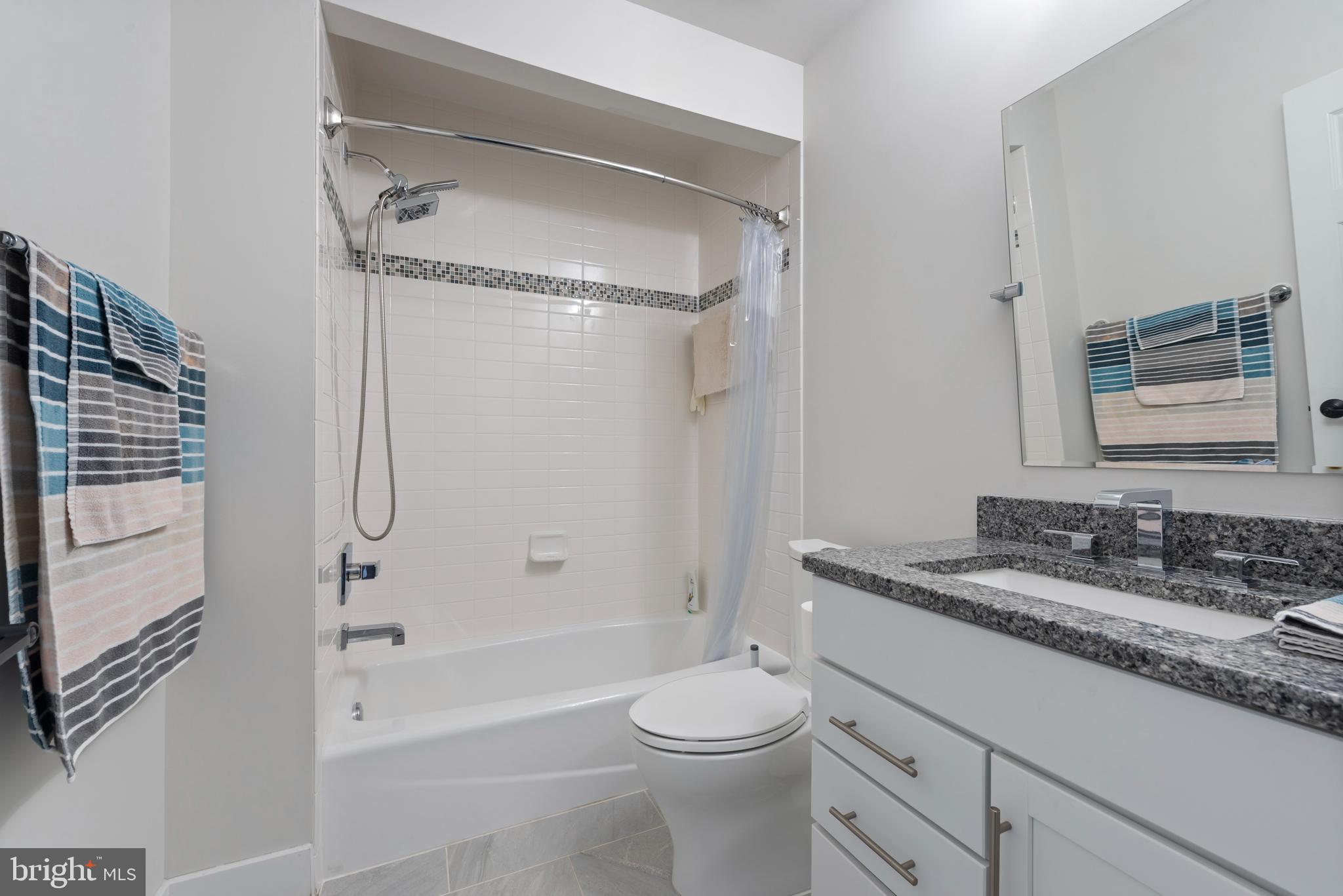 922 South Streeper Street Baltimore, MD 21224 - Photo 26 of 33 a bathroom with a granite countertop sink toilet and shower