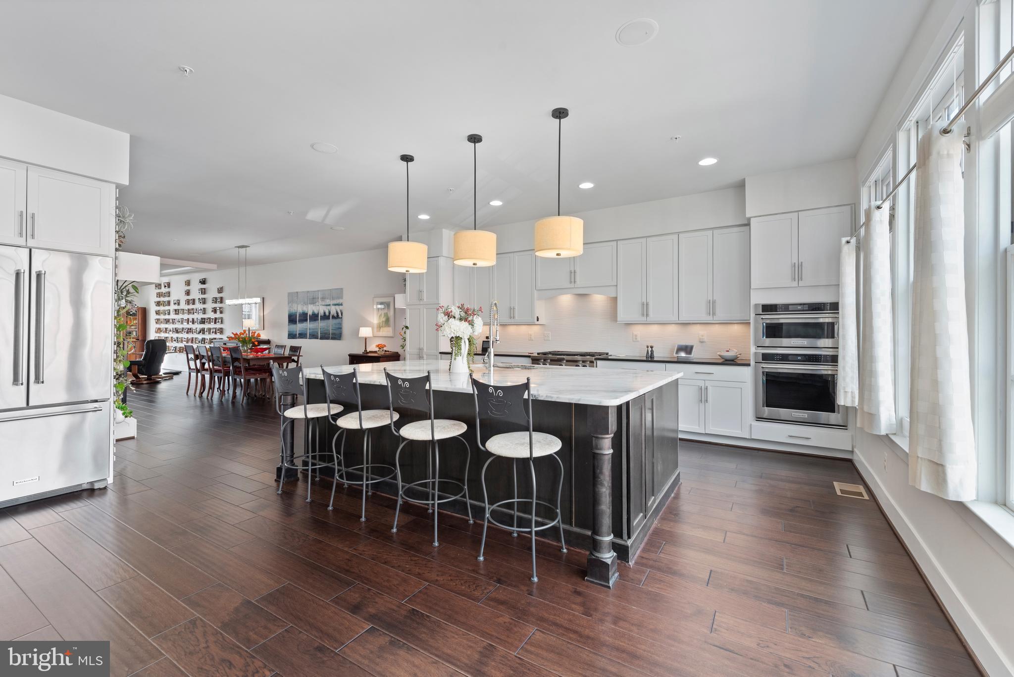 922 South Streeper Street Baltimore, MD 21224 - Photo 4 of 33 a large kitchen with lots of counter space a sink appliances and dining table