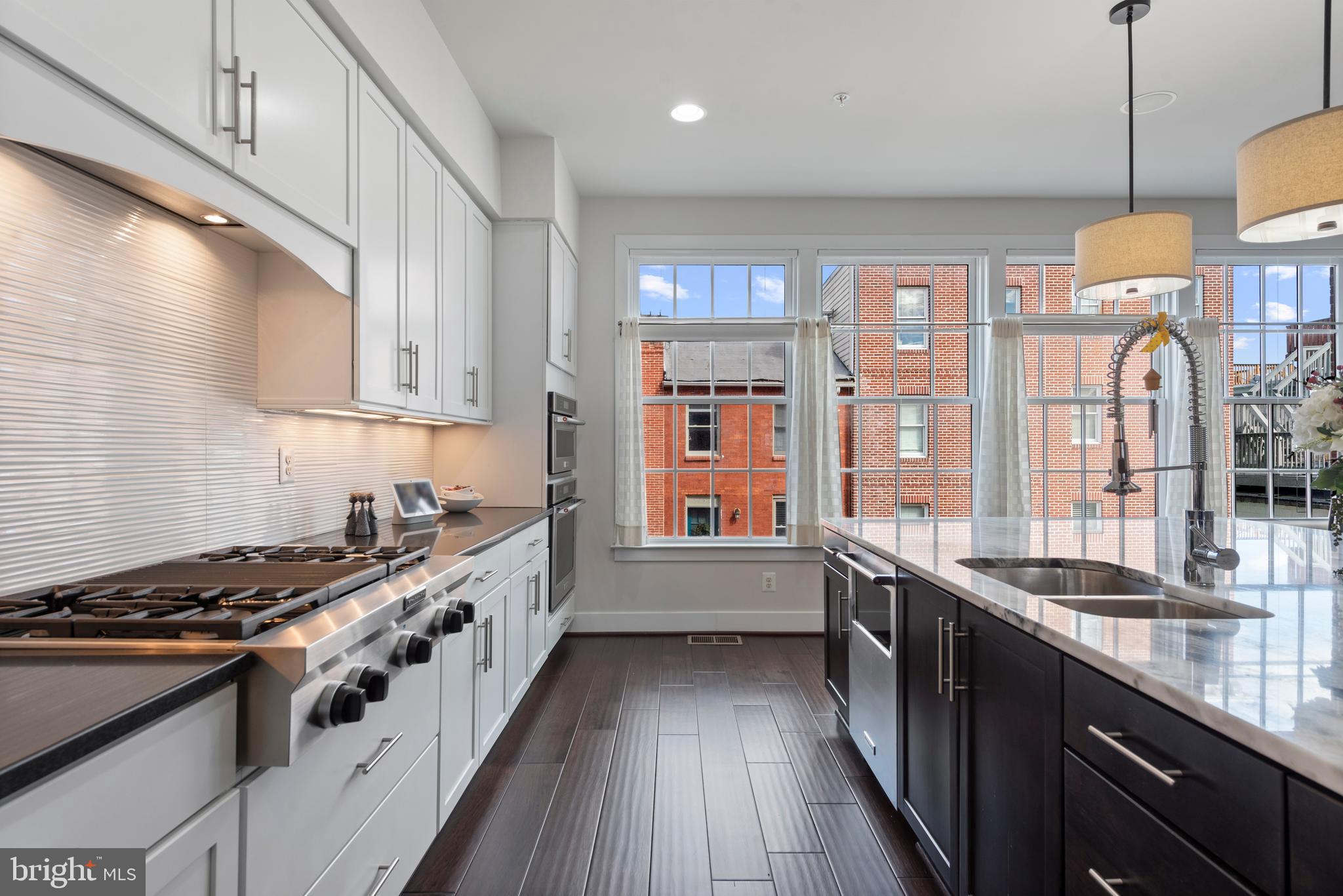 922 South Streeper Street Baltimore, MD 21224 - Photo 5 of 33 a kitchen with stainless steel appliances granite countertop a stove and a sink