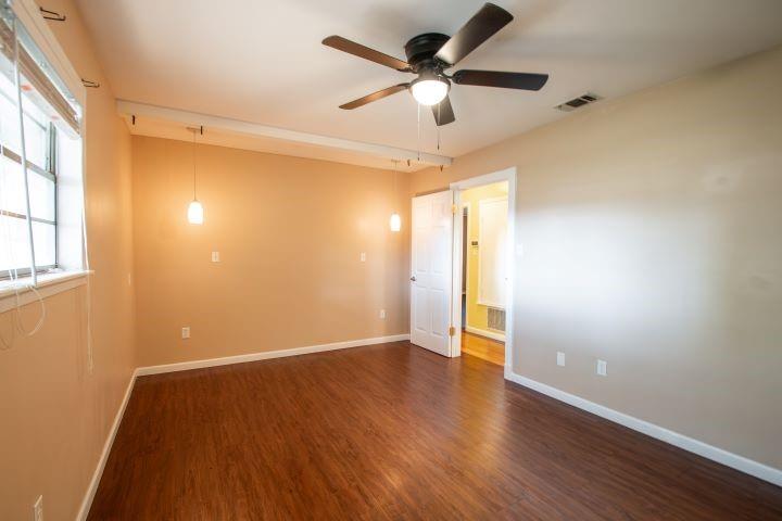 319 North Spruce Street Van, TX 75790 - Photo 9 of 33 an empty room with wooden floor fan and windows