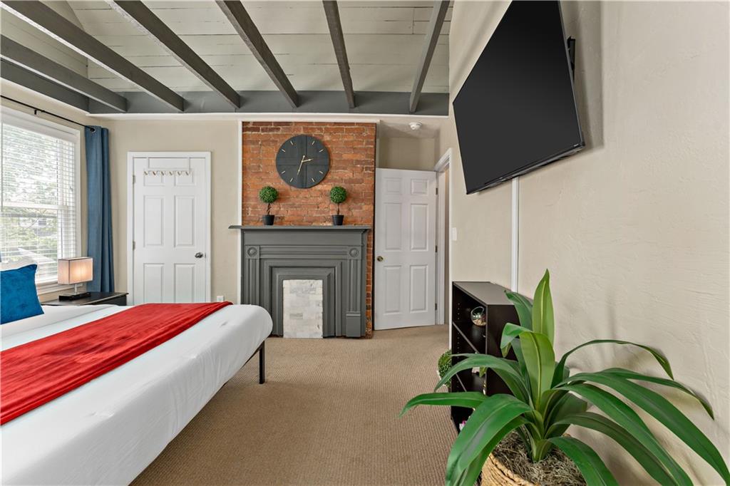 239 Albert Street Pittsburgh, PA 15211 - Photo 12 of 34 a bedroom with bed and a potted plant