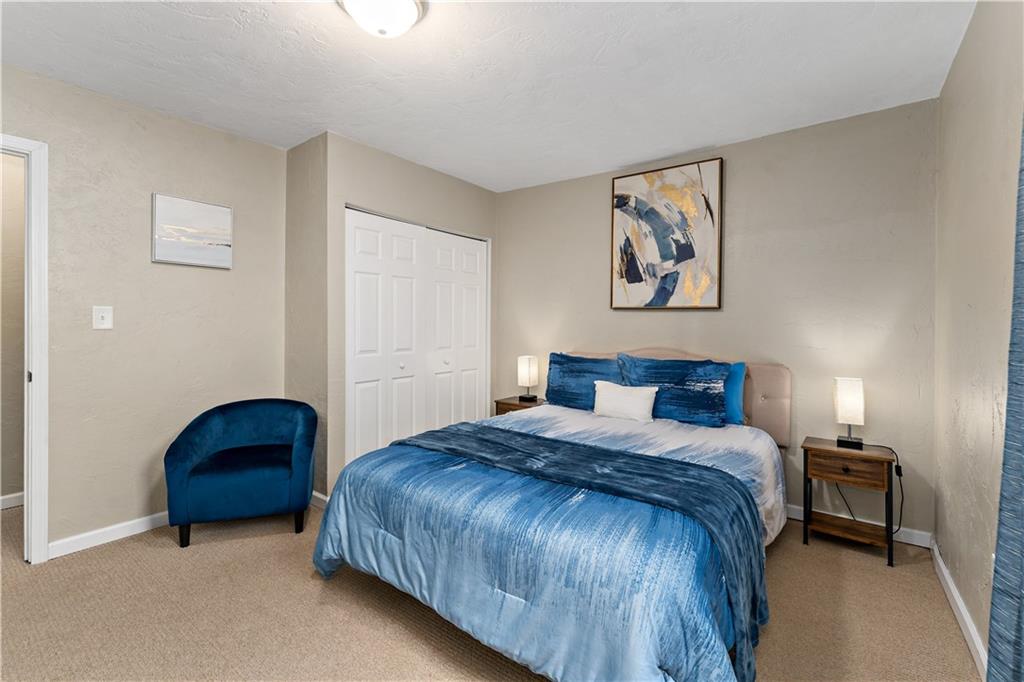 239 Albert Street Pittsburgh, PA 15211 - Photo 15 of 34 a bedroom with a bed and a lamp on dresser